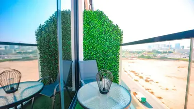 two tables on a balcony with a view of the beach at Magnificent studio-One of kind in Dubai in Dubai