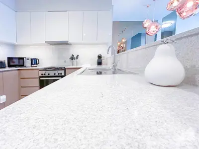 a white kitchen with a white vase sitting on a counter at Spacious 3.5 Bedroom Apartment in Burj Royale in Dubai