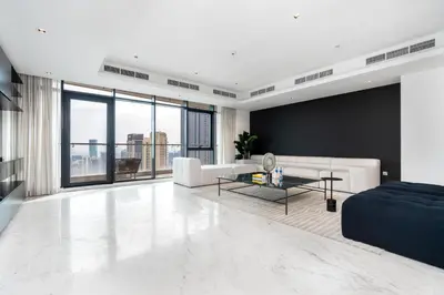 a living room with a couch and a table at Luxe 6BR Penthouse with Burj View & Private Cinema in Dubai