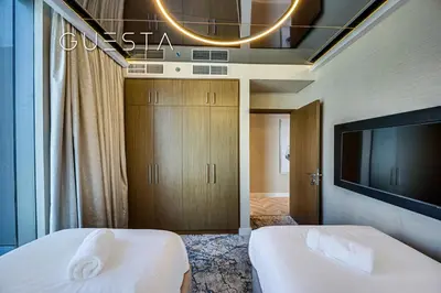 a hotel room with two beds and a flat screen tv at 52 I 42 Tower by Emaar, Dubai Marina in Dubai