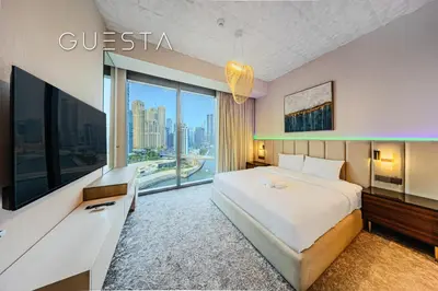 a hotel room with a bed and a large window at 52 I 42 Tower by Emaar, Dubai Marina in Dubai