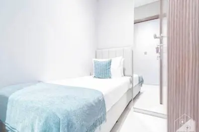 a white bedroom with a bed and a window at Luxury Burj Royale 4Bed Balcony Burj Khalifa View in Dubai