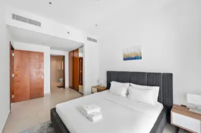 a bedroom with a large white bed with white pillows at Stylish 1 BR in Dubai Marina in Dubai