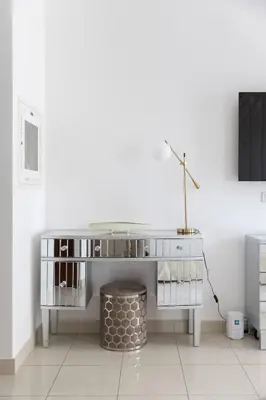 a white desk with a lamp on top of it at Downtown Studio next to Dubai Opera, Dubai Mall in Dubai