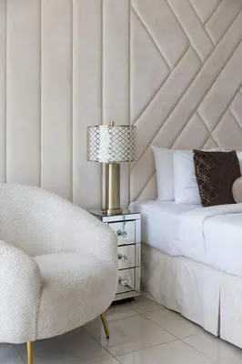 a bedroom with a bed and a chair and a lamp at Downtown Studio next to Dubai Opera, Dubai Mall in Dubai