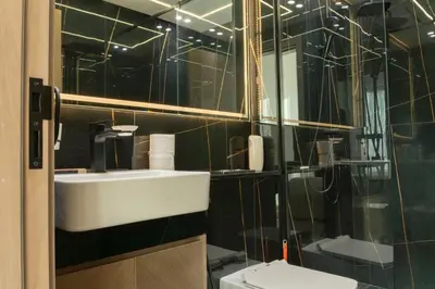 a bathroom with a sink and a mirror and a toilet at Luxe 1BR 15mins-Beach Best Infinity Pool -Jumeirah Village Circle, JVC ,Dubai in Dubai