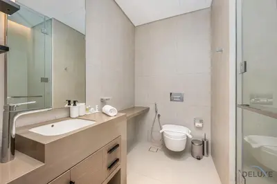 a bathroom with a sink and a toilet at Ultra Luxurious 4BR with Assistant Room in The Address Residences, JBR by Deluxe Holiday Homes in Dubai
