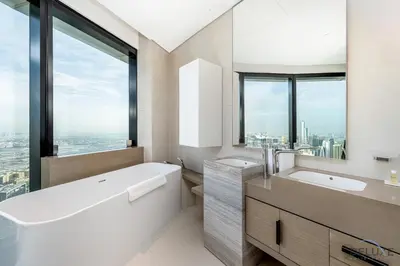 a bathroom with a tub and a sink and a window at Ultra Luxurious 4BR with Assistant Room in The Address Residences, JBR by Deluxe Holiday Homes in Dubai