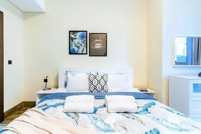 a bedroom with a large bed with two pillows at Jone brand-new aptm near Dubai Mall & Burj Khalifa in Dubai