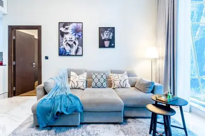a living room with a couch and a table at Jone brand-new aptm near Dubai Mall & Burj Khalifa in Dubai