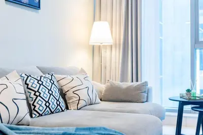 a living room with a couch with pillows on it at Jone brand-new aptm near Dubai Mall & Burj Khalifa in Dubai