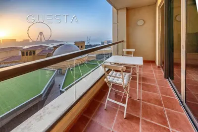 a balcony with a table and a view of a stadium at Jumeirah Beach Residence - Rimal 3, Dubai Marina in Dubai