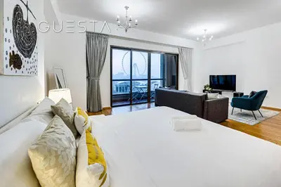 a bedroom with a large bed and a living room at Jumeirah Beach Residence - Rimal 3, Dubai Marina in Dubai