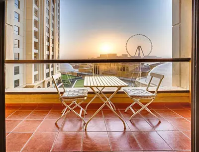 a table and chairs on a balcony with a view of a city at Jumeirah Beach Residence - Rimal 3, Dubai Marina in Dubai