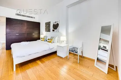 a bedroom with a bed and a desk and a mirror at Jumeirah Beach Residence - Rimal 3, Dubai Marina in Dubai