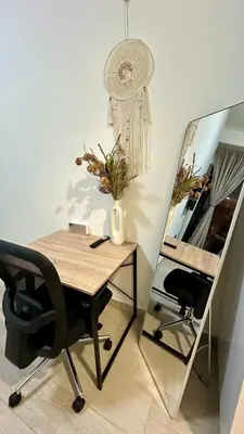 a desk with a mirror and a chair in a room at Luxury Studio with big balcony Azizi Riviera Meydan in Dubai