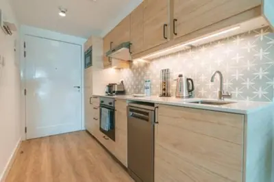 a kitchen with a sink and a counter top at Cozy Chic Studio with Balcony The Greens Dubai in Dubai