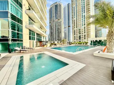 a swimming pool in a building with tall buildings at SettlerHomes- Breathtaking 2BR Marina High-Floor in Dubai