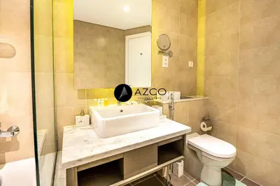 a bathroom with a sink and a toilet at Panoramic 2BR - 3 Balconies & Canal Views - Damac Maison Prive by AZCO Holiday Homes in Dubai
