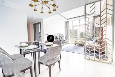 a dining room with a table and chairs at Panoramic 2BR - 3 Balconies & Canal Views - Damac Maison Prive by AZCO Holiday Homes in Dubai