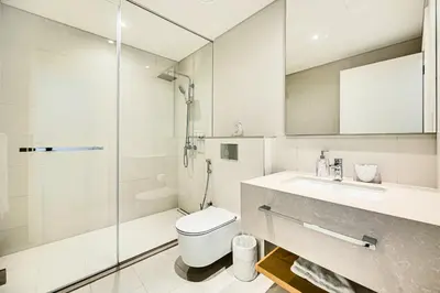 a bathroom with a toilet and a sink and a shower at Stylish sea view from new 2BD La Vie in Dubai