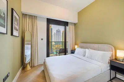 a bedroom with a bed and a window with a view at Daniels Luxe 3BR Downtown with Skyline View in Dubai