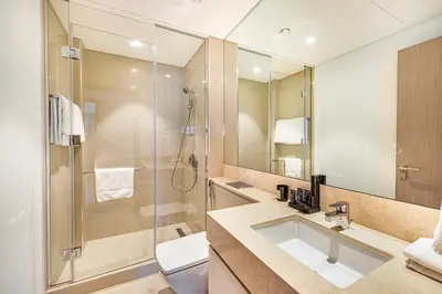 a bathroom with a sink and a shower at Daniels Luxe 3BR Downtown with Skyline View in Dubai