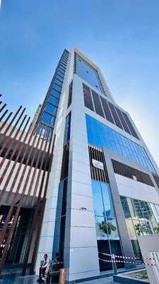 two people sitting in front of a tall building at Upscale Studio Apartment Palm View with Big Balcony Free Parking by Belvilla in Dubai