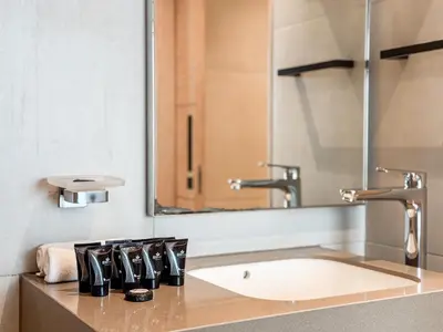 a bathroom with a sink and a mirror at SettlerHomes - Chic Jumeirah Gate with Beach Access in Dubai