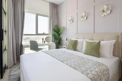 a bedroom with a large white bed with a desk at Frank Porter - Socio Tower 2 in Dubai