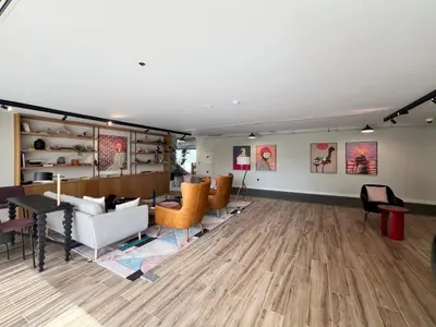 a living room with furniture and paintings on the walls at Frank Porter - Socio Tower 2 in Dubai