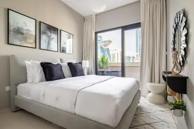 a bedroom with a large bed and a large window at Frank Porter - Zada Tower in Dubai