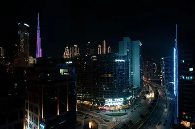 a view of a city at night with at Panoramic LUX Apartment with Burj Khalifa View in Dubai