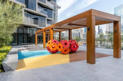 a pavilion with colorful sculptures on a sidewalk at Luxury 1BR The Address Opera, Downtown Dubai in Dubai