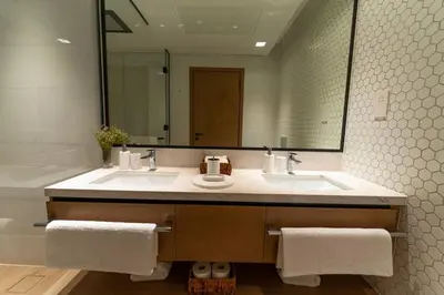 a bathroom with a sink and a large mirror at The Palace 405 I Luxury 2BD I Dubai Creek Harbour in Dubai