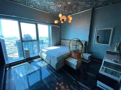 a bedroom with a bed in a room with windows at Luxurious 2BR in MBL JLT Brand New in Dubai