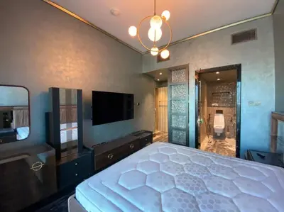 a bedroom with a large bed and a flat screen tv at Luxurious 2BR in MBL JLT Brand New in Dubai