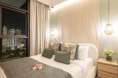 a bedroom with a white bed and a window at Burj Crown - New Sky High, Near Burj Khalifa, Boulevard View, Opposite Dubai Mall in Dubai