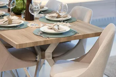 a wooden table with chairs and plates and wine glasses at Burj Crown - New Sky High, Near Burj Khalifa, Boulevard View, Opposite Dubai Mall in Dubai