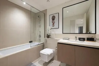 a bathroom with a toilet and a sink and a tub at Burj Crown - New Sky High, Near Burj Khalifa, Boulevard View, Opposite Dubai Mall in Dubai