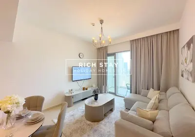 a living room with a couch and a table at Incredible 1BR, Downtown Views II near Dubai Mall in Dubai