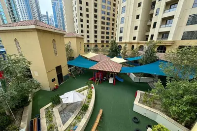 an overhead view of a courtyard with tables and umbrellas at Luxury Living on the Top Floor Full Marina View in Dubai