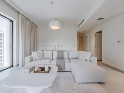 a white living room with a large white couch at Dubai Creek Escape: Luxury 3BR Nautical Grandeur in Dubai