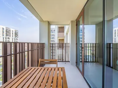 a wooden bench on the balcony of a building at Dubai Creek Escape: Luxury 3BR Nautical Grandeur in Dubai