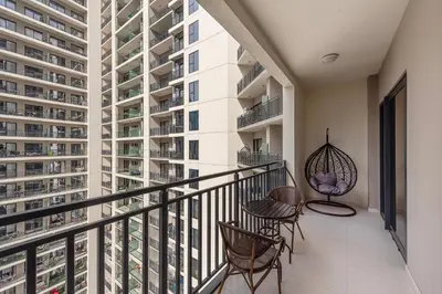 a balcony with chairs and tables and a building at ALiving Classy 1BR I Close to Dubai Mall I Zada Tower, Business Bay- 1617 in Dubai