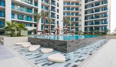 a swimming pool in front of a large apartment building at ALiving Classy 1BR I Close to Dubai Mall I Zada Tower, Business Bay- 1617 in Dubai