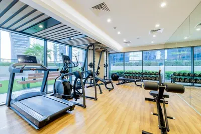 a gym with treadmills and elliptical machines at ALiving Classy 1BR I Close to Dubai Mall I Zada Tower, Business Bay- 1617 in Dubai