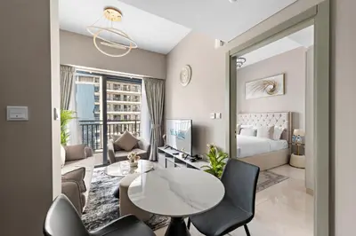 a hotel room with a bed and a table and chairs at ALiving Classy 1BR I Close to Dubai Mall I Zada Tower, Business Bay- 1617 in Dubai