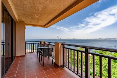a balcony with a view of the water at Anantara South Residences I Stunning 1 Bedroom Apartment in Dubai