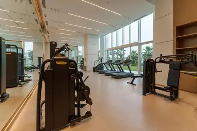 a gym with treadmills and elliptical machines at Maison Privee - Seaside JBR Living w/ Open Sea & Bluewaters Views in Dubai